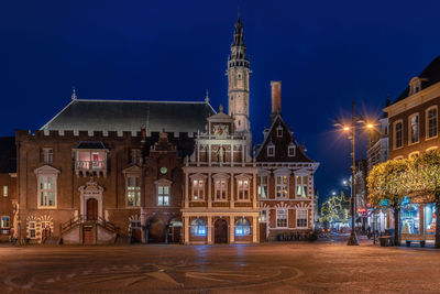 Illuminated building against sky at night
