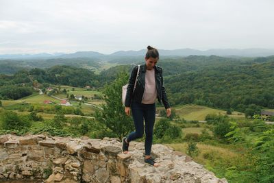 Full length of man standing on mountain against sky