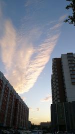 Low angle view of buildings against cloudy sky