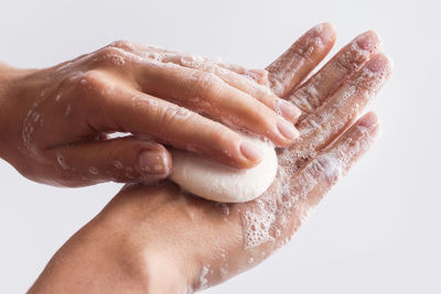 Cropped image of woman cleaning hand with soap