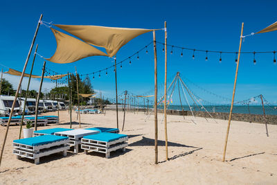 Camper rv cars on white sand beach against blue sky at cha-am, phetchaburi, thailand. 