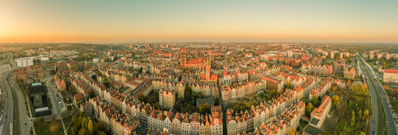 High angle view of illuminated cityscape against sky during sunset