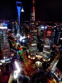 High angle view of city lit up at night