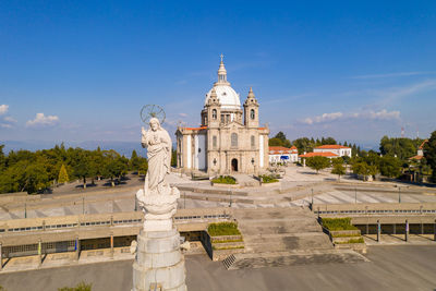 Statue of historic building against blue sky