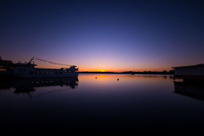 Scenic view of silhouette bridge against sky at sunset