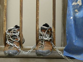 Close-up of old shoes against building