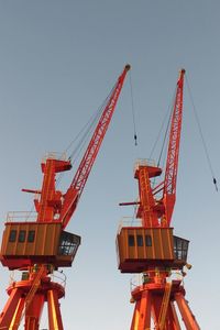 Low angle view of crane against clear sky