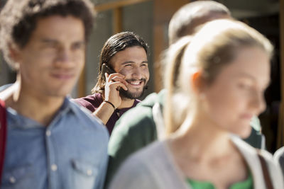 Young man on street talking via cell phone