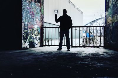 Silhouette man standing in corridor