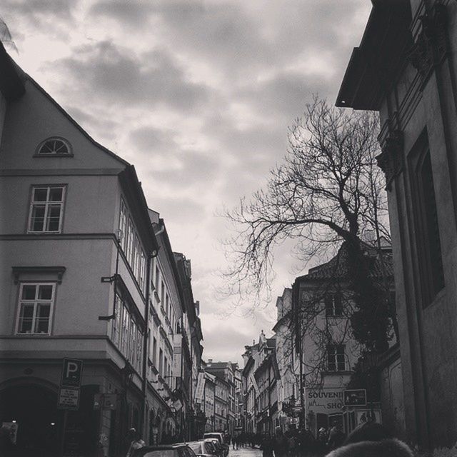 building exterior, architecture, built structure, sky, car, transportation, cloud - sky, residential building, street, residential structure, tree, bare tree, land vehicle, city, building, cloud, cloudy, house, mode of transport, road