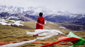 WOMAN ON SNOWCAPPED MOUNTAINS