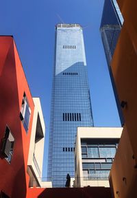 Low angle view of modern buildings against clear blue sky