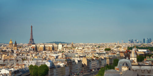 Buildings in city against clear sky