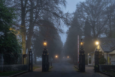 Illuminated street against sky