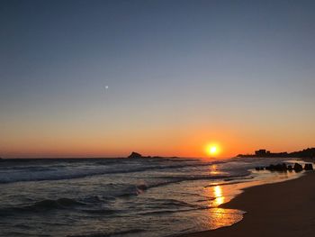 Scenic view of sea against clear sky during sunset