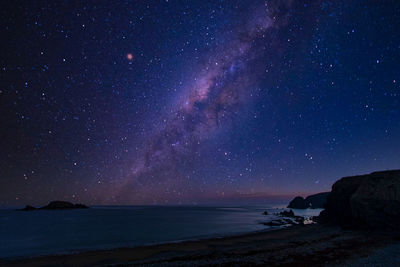 Scenic view of sea against sky at night