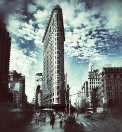 Low angle view of modern building against cloudy sky