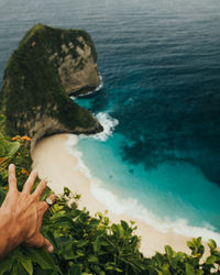 High angle view of hand by sea