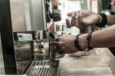 Close-up of hand holding coffee cup