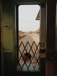 Railroad tracks seen through window