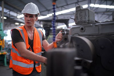 Rear view of man working in factory