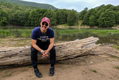 Full length of young man against trees at lake