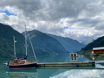 Sailboat in lake against sky