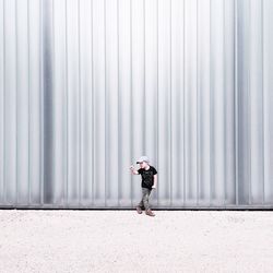 Full length of woman standing by railing