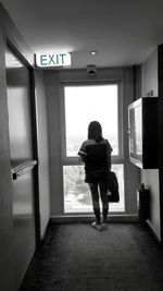 Full length of woman standing on railing