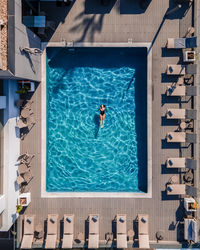 High angle view of woman swimming in pool