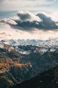 Dramatic sky over snow capped mountains in fall colors, saalbach, salzburg, austria