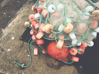 High angle view of commercial fishing net with floats on pier