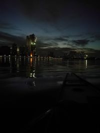 Illuminated cityscape against sky at night