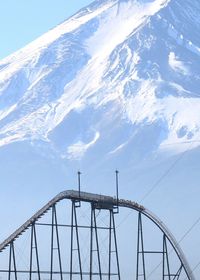 Low angle view of bridge against cloudy sky