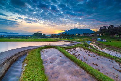 Scenic view of lake against sky during sunset