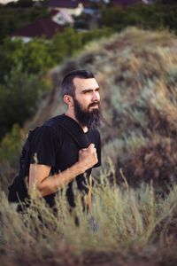 Portrait of a man with a beard on the background of nature and mountains