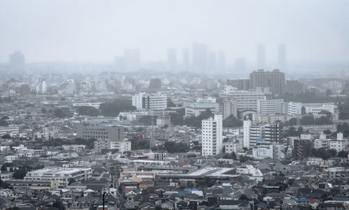 High angle view of buildings in city against sky