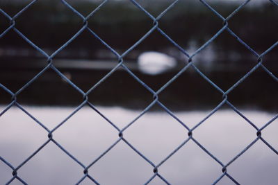 Full frame shot of chainlink fence against sky