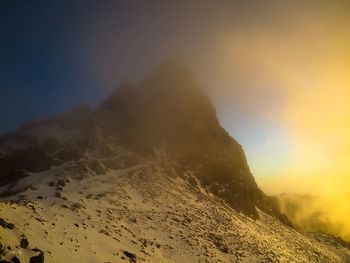 Scenic view of rocky mountains against sky during sunset