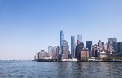 Modern buildings in city against clear sky