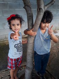 Portrait of girl with brother gesturing 