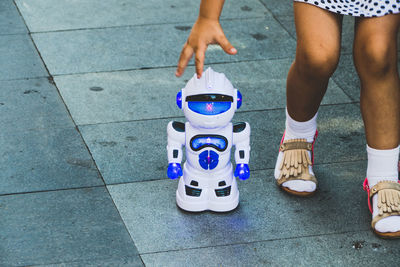 Low section of woman standing on tiled floor