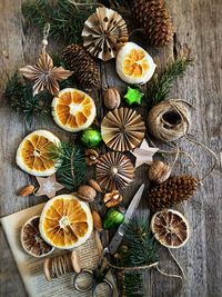 New year's decor in the scandi style of cones, nuts, spruce branches and orange slices. cozy house