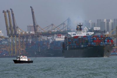 Commercial dock by sea against sky