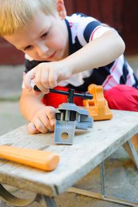 Cute boy playing with toy outdoors