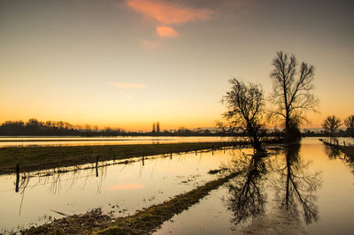 Scenic view of calm lake at sunset