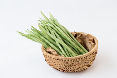 Close-up of fresh green basket against white background