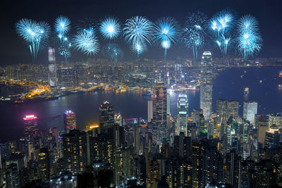 Illuminated city against sky at night