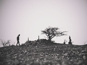 Man standing on field against clear sky