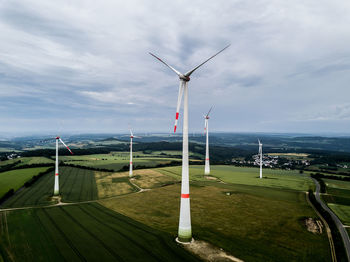 Windmill on field against sky